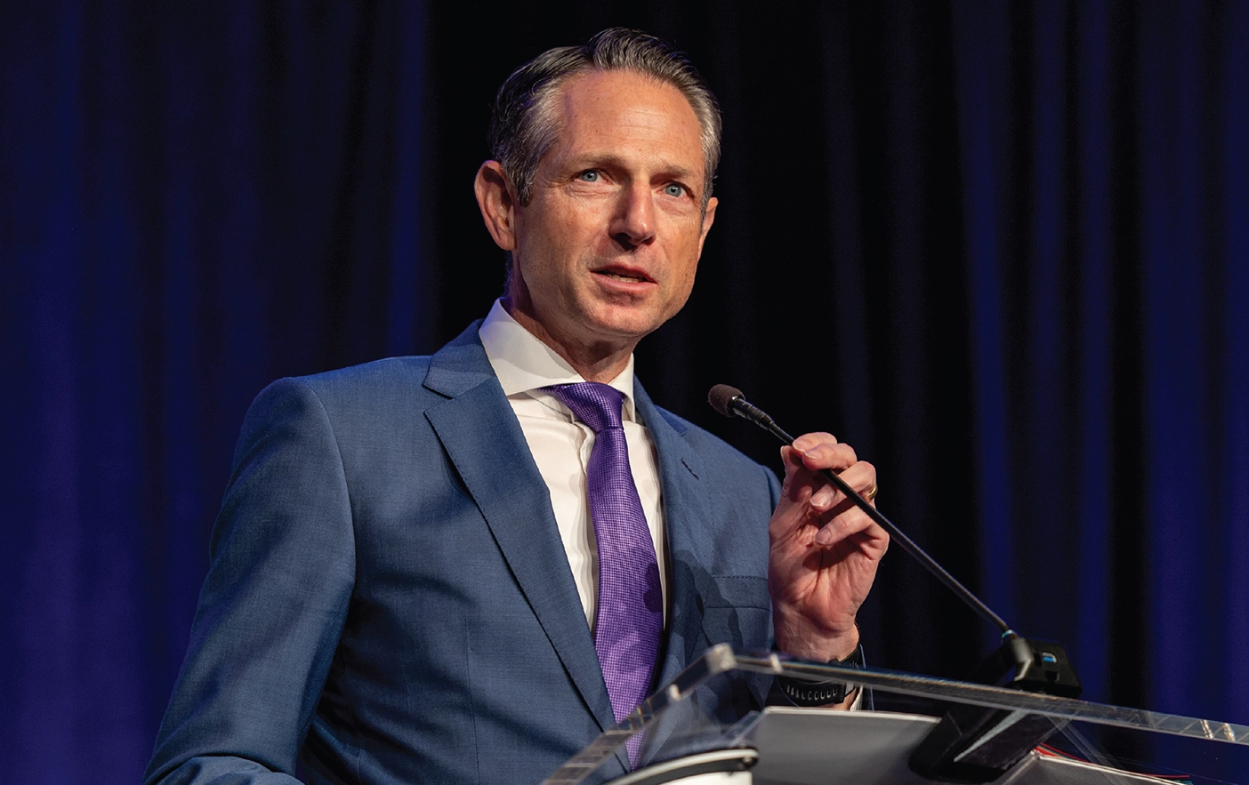 Derek Miller, new BYU Alumni Association President, speaks at a podium.