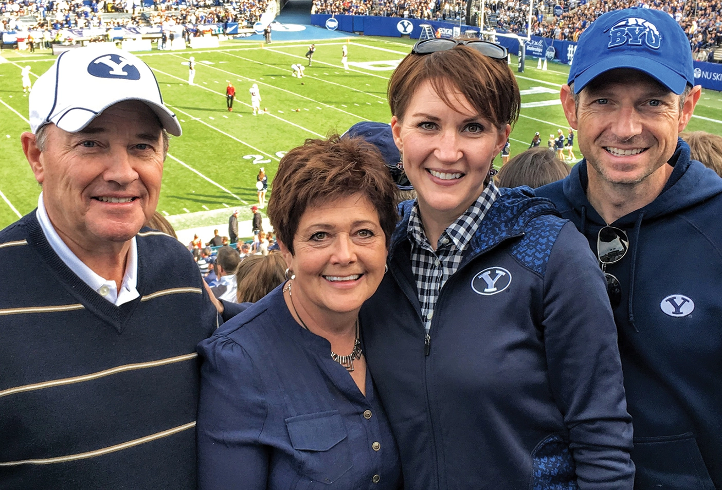 Derek Miller with his wife and two others at a BYU football game.