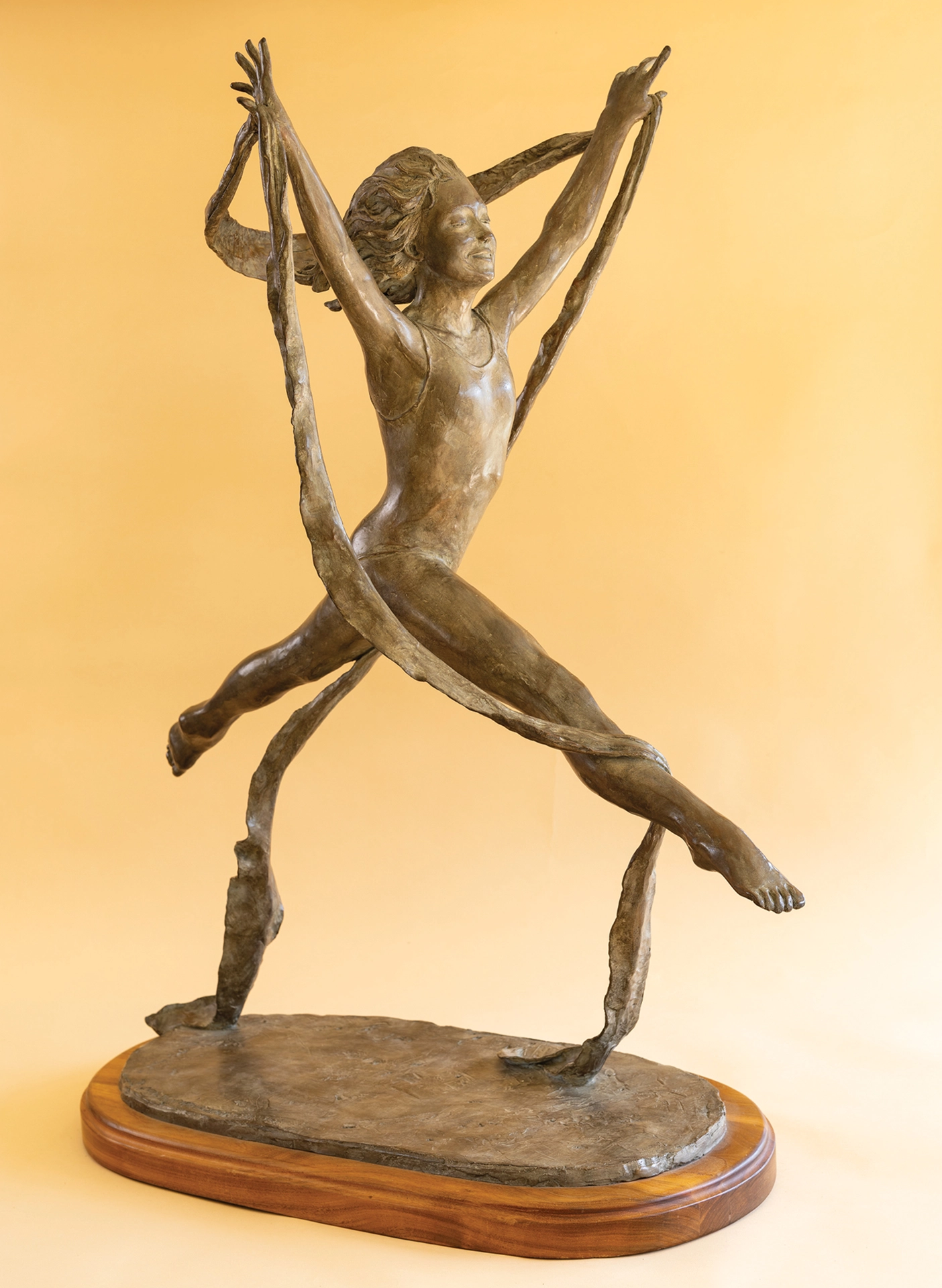 A sculpture of a woman leaping.