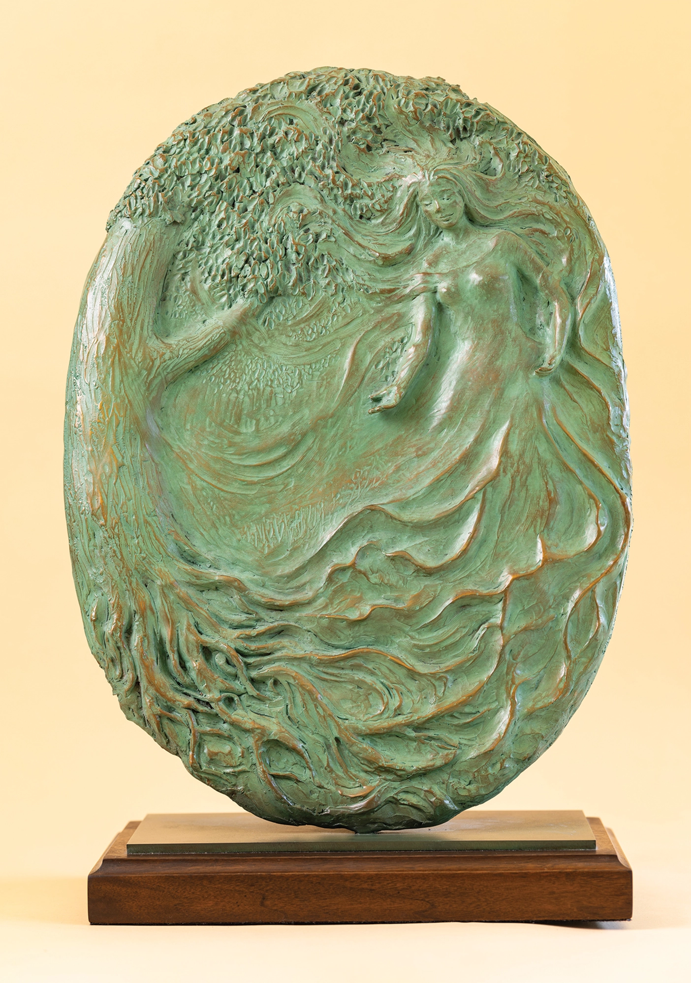 Sculpture of a tree intertwined with a female figure.