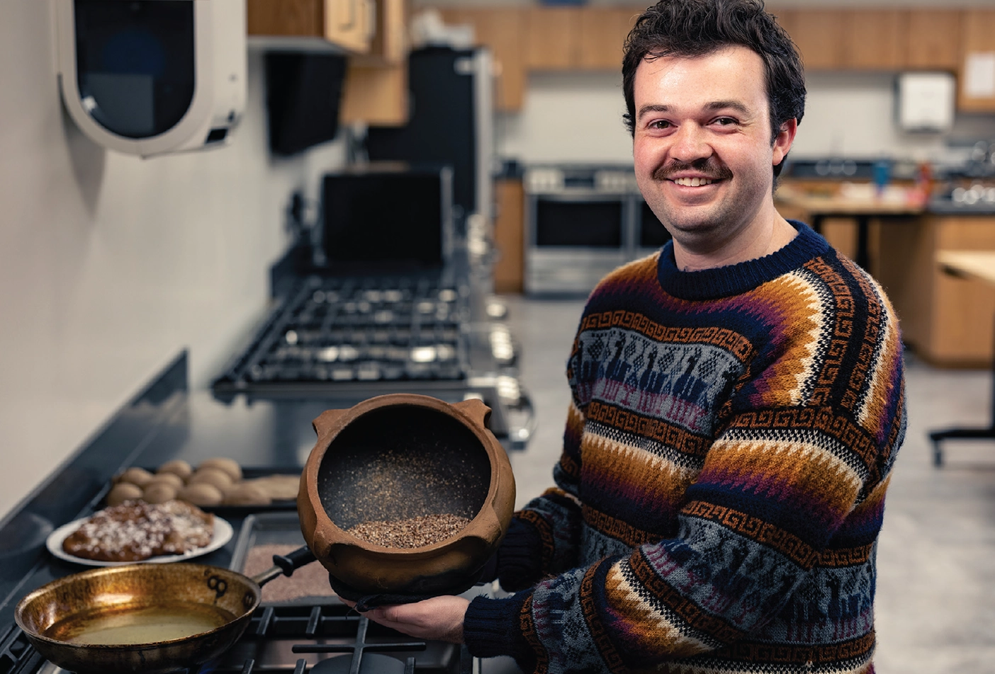 Paxton Webster holds an authentic Bolivian pot filled with popped quinoa.