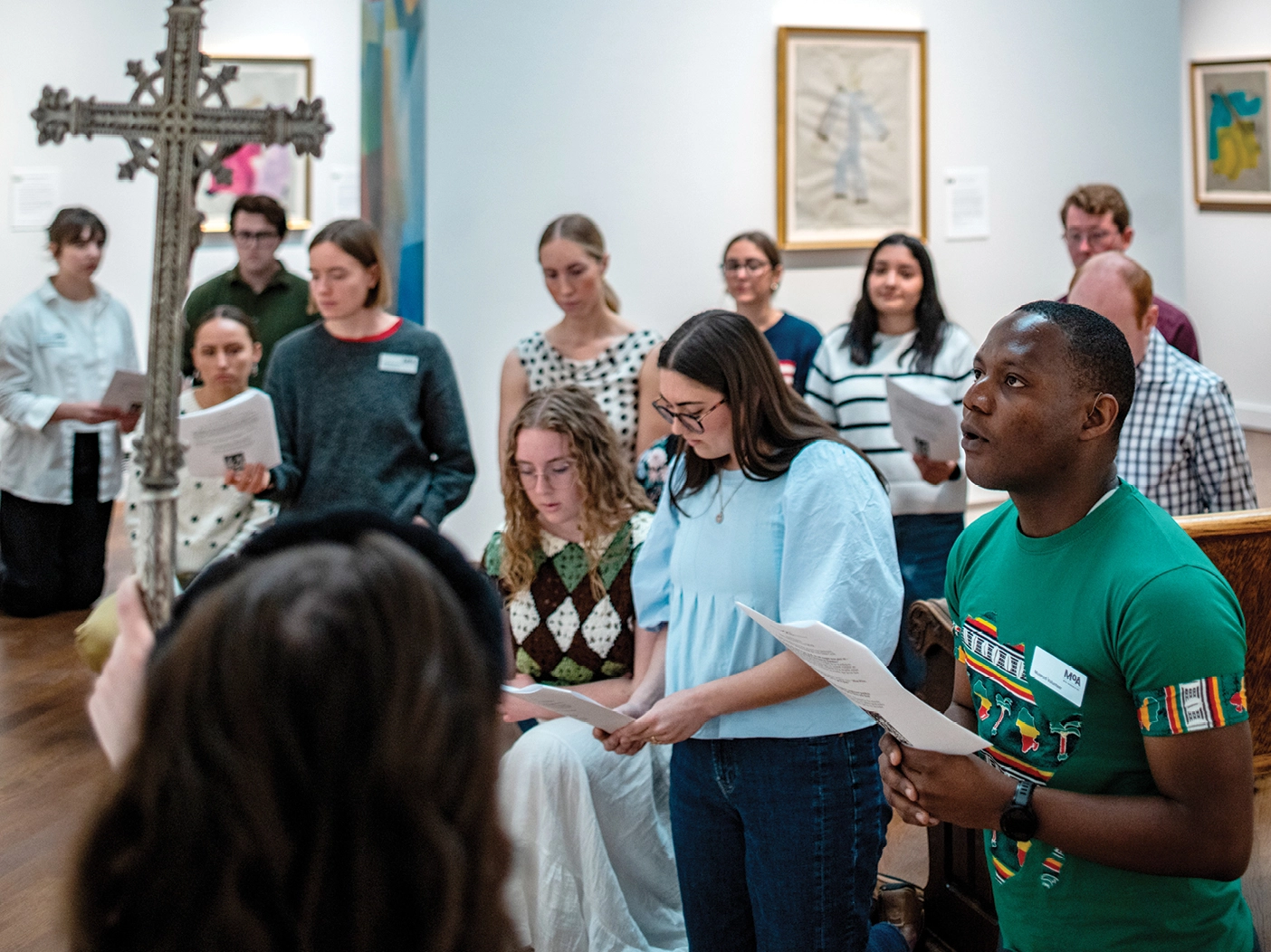 Members of BYU's Newman Club gather at a BYU MOA exhibit of the stations of the cross.