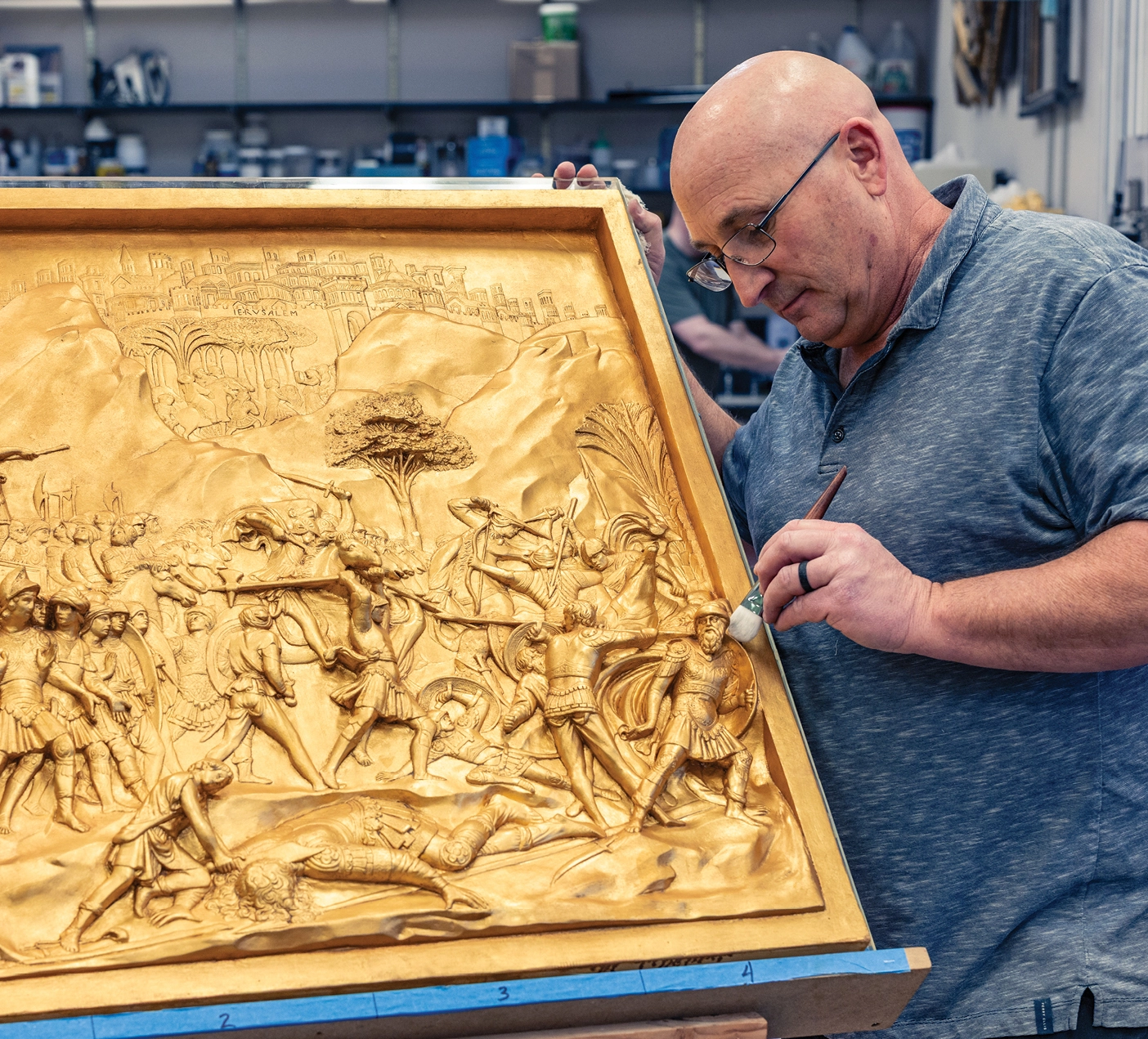 John Adams prepares a panel for the BYU Museum of Art exhibit Gilded Paradise.