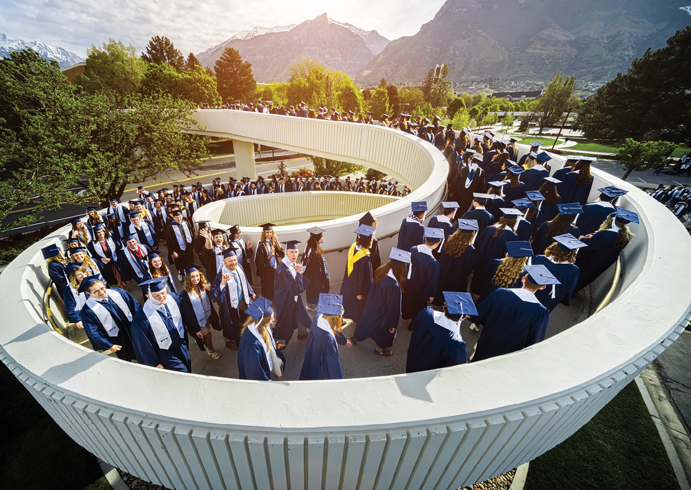 BYU graduates file toward the Marriott Center for graduation.