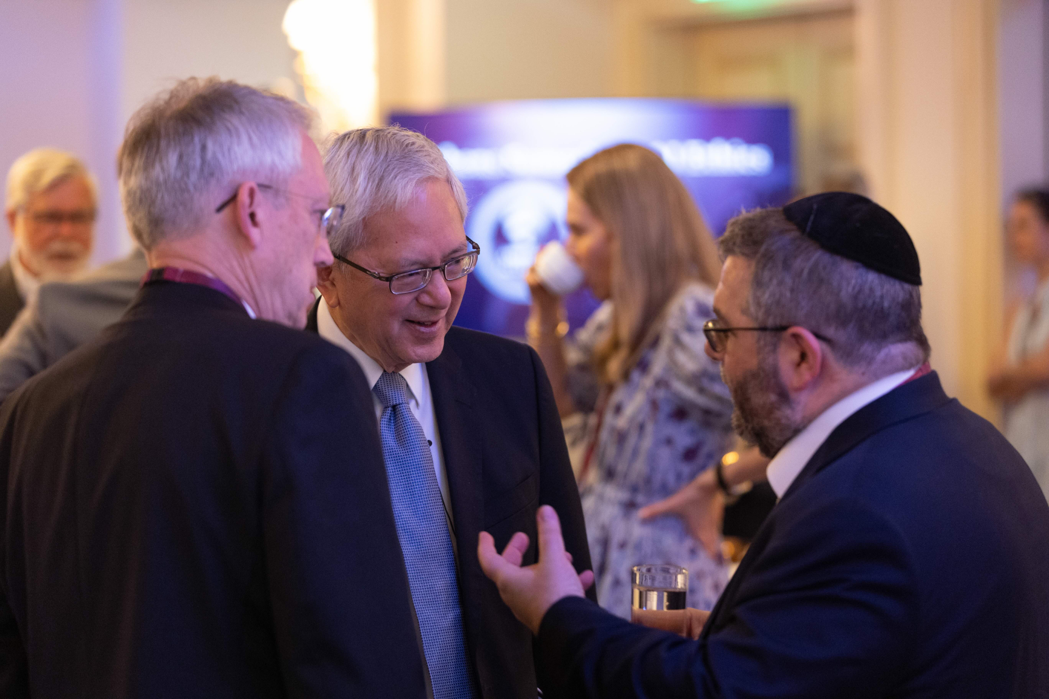 Elder Gerrit W. Gong of the Quorum of the Twelve Apostles talks with Larry Howell and Rabbi Daniel Feldman during the Athens Summit on AI Ethics in Athens, Greece, on Tuesday, May 26, 2026.