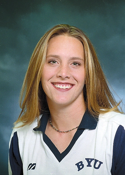 Color portrait of a smiling female volleyball player wearing a white BYU jersey.