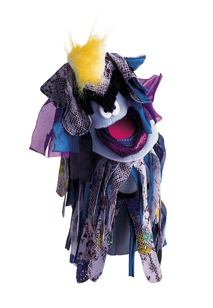 Ragged villain puppet assembled from dark purple, black, blue, and green fabric scraps.