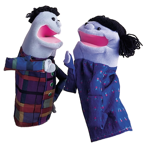 Two human-shaped hand puppets with pale green faces, black hair, and colorful clothing face each other.