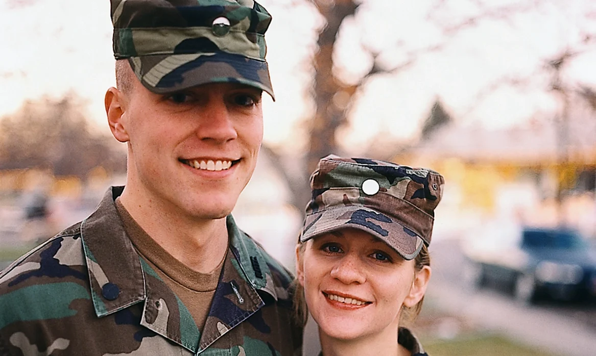 Matt and Mandy stand together in their army uniforms.