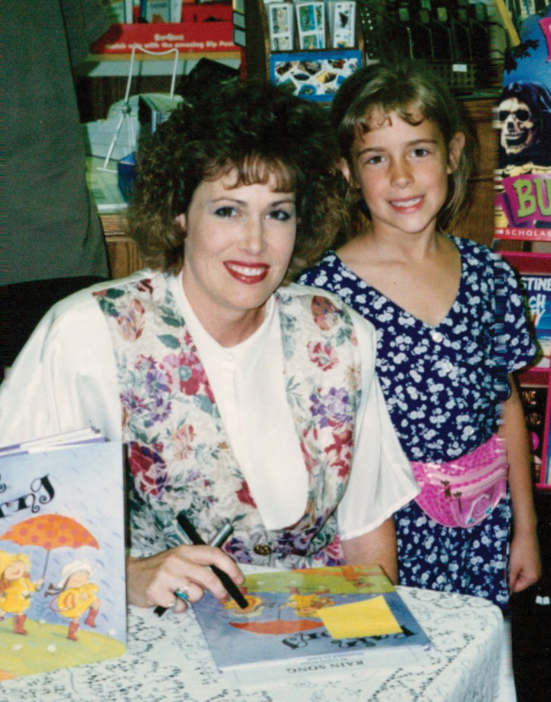 Mother Lezlie Evans and daugther Aubrey Hartman pose together with Lezlie's book.