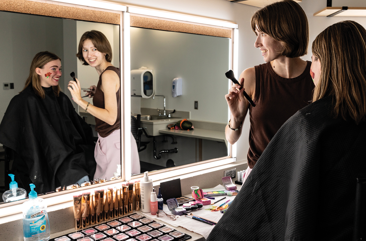 Students Meili I. Hollingshaus (’27), seated, and A. Juliana Alley (’27) use color-adjustable lights, which help match an actor’s makeup to a show’s lighting in the new BYU Arts Building.