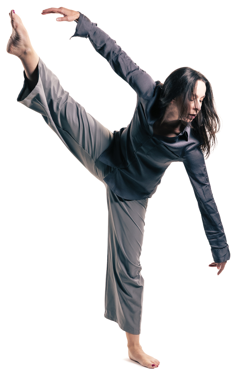 BYU dance professor Kathleen A. Monson poses with one pointed foot in the air.