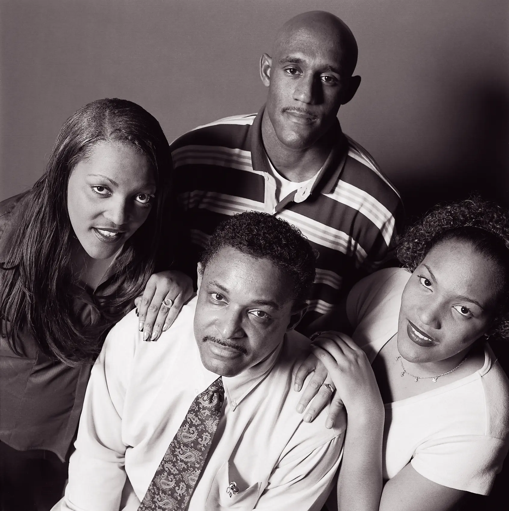 A father (Willie Brown) and four adult children (Anesha, Quintina, and Tyrone) pose together.